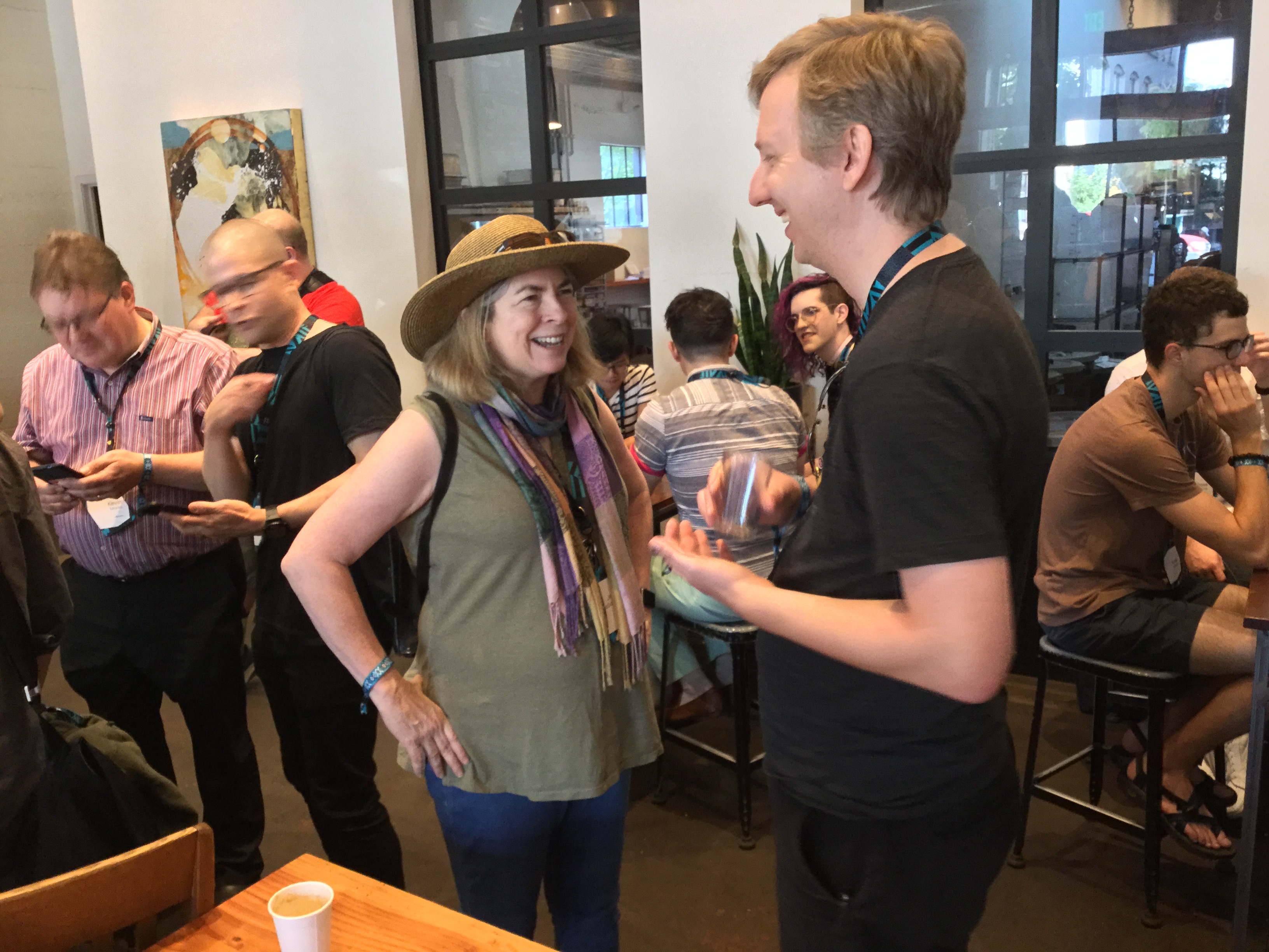 IndieWeb folks at XOXO Social, Cup and Bar cafe, mostly standing and having animated discussions including Kevin Marks, Jean, gRegorLove