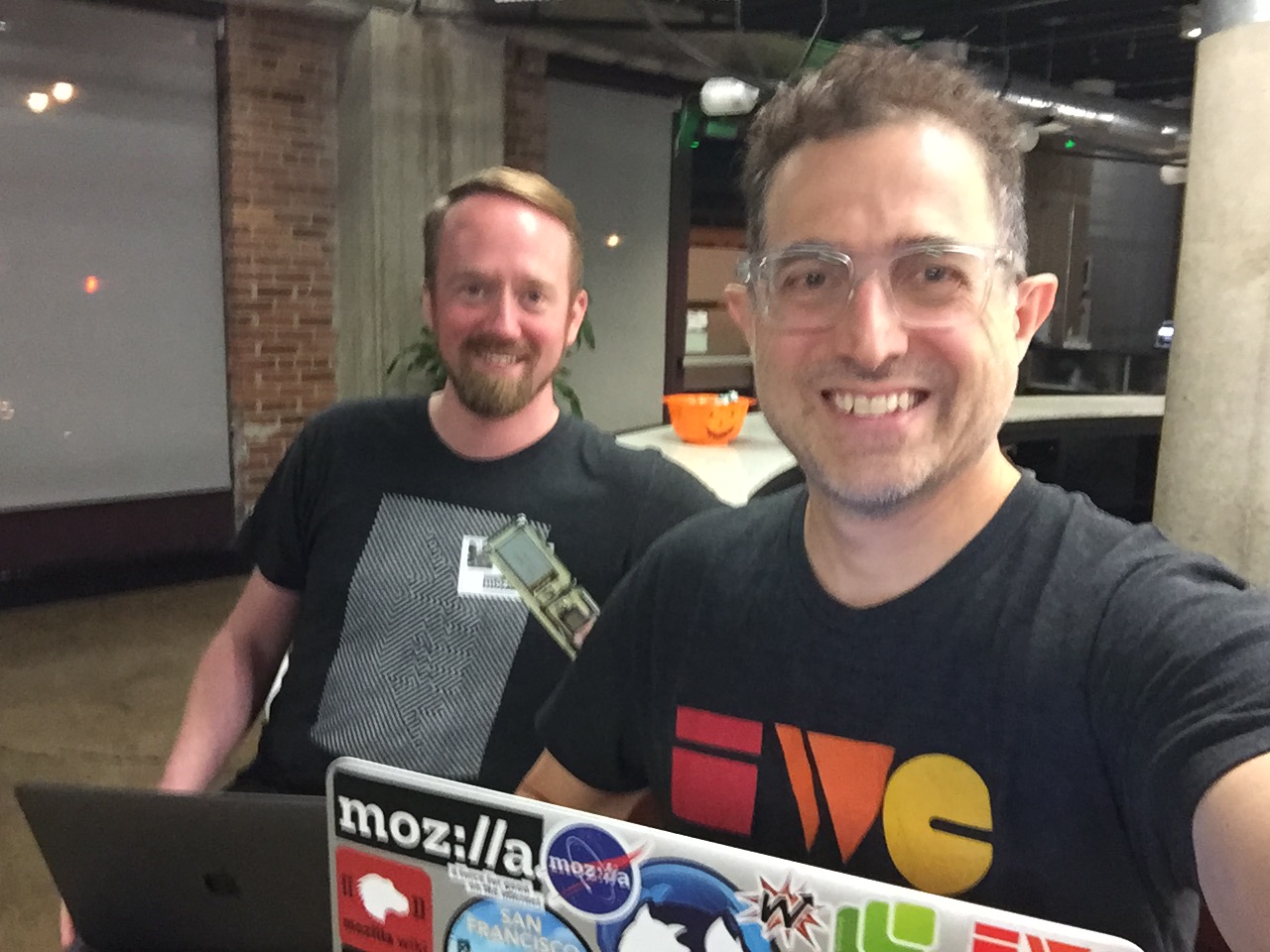 Matt Davis and Tantek at Homebrew Website Club San Francisco inside Mozilla offices sitting at the counter with mini pumpkins in the background
