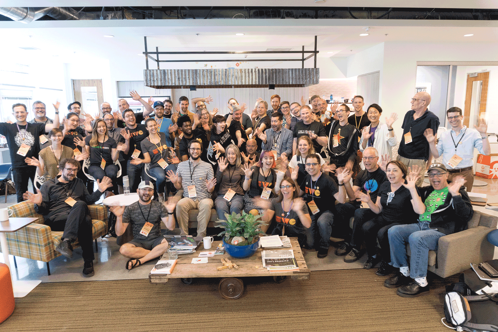 IndieWeb Summit Animated group photo of about 50 participants sitting and standing together in a few rows in the Mozilla Portland office, waving their hands like jazz hands